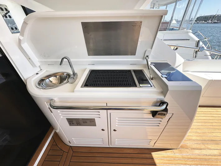 Forever Young Yacht Photos Pics Outdoor kitchen on 2019 Sunseeker Predator 57 yacht with sink and grill.