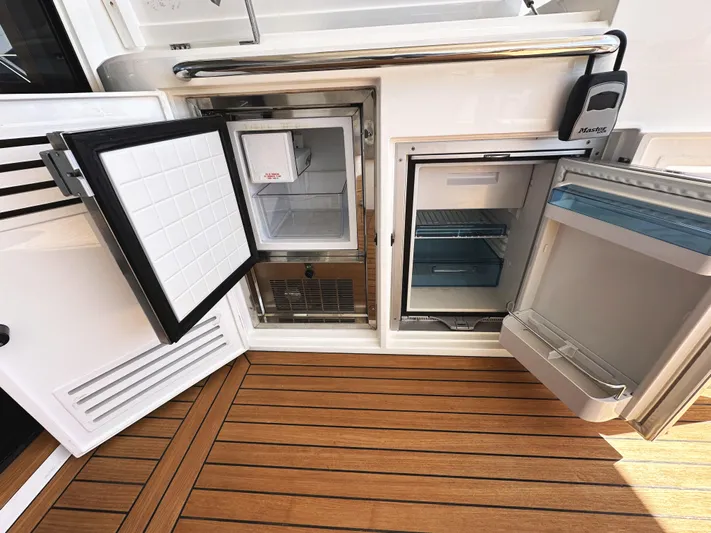 Forever Young Yacht Photos Pics Sunseeker Predator 57 yacht, 2019 model, featuring open refrigerators on teak deck.
