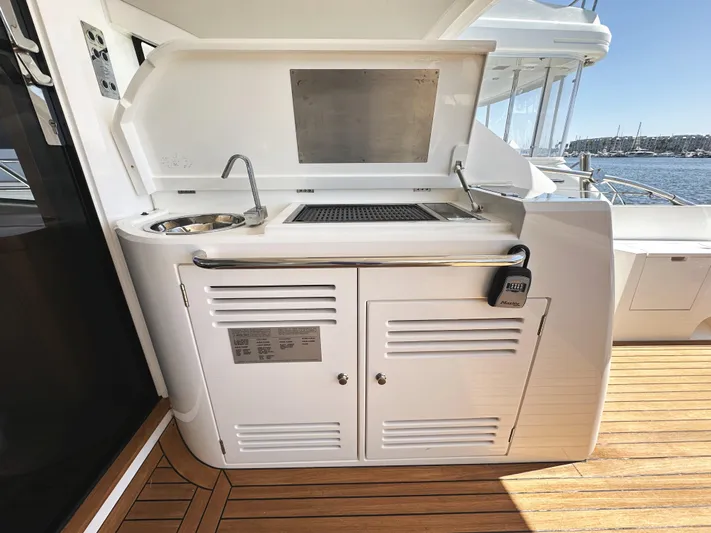 Forever Young Yacht Photos Pics Outdoor kitchenette on 2019 Sunseeker Predator 57 yacht with sink and grill.