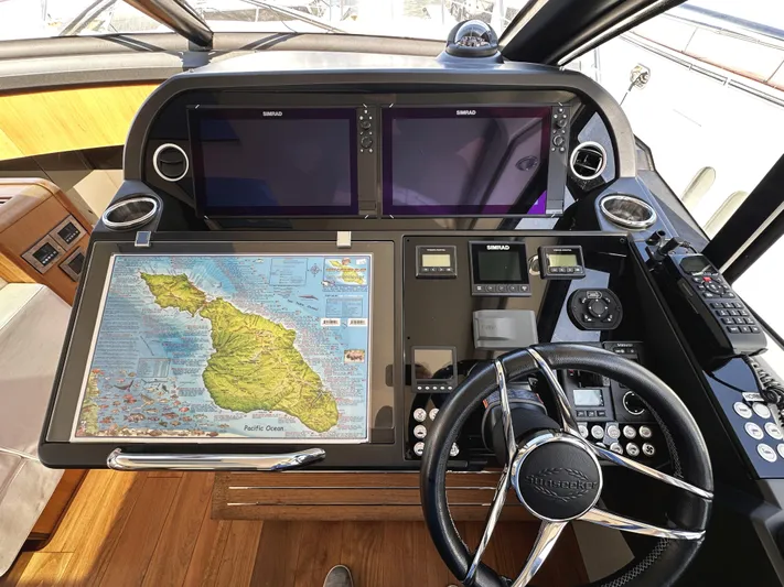 Forever Young Yacht Photos Pics Control panel of a 2019 Sunseeker Predator 57 yacht with navigation equipment and map.