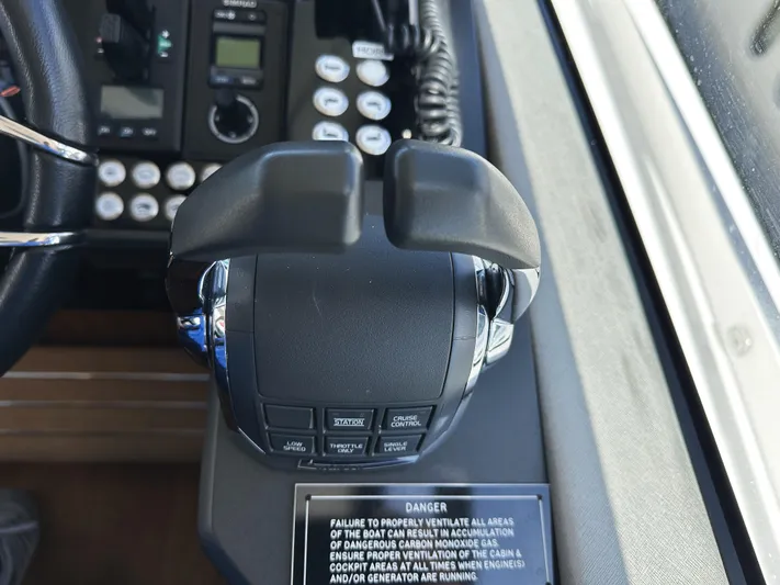 Forever Young Yacht Photos Pics Control panel of a 2019 Sunseeker Predator 57 yacht, featuring throttle and warning label.