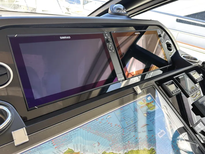 Forever Young Yacht Photos Pics Control panel of 2019 Sunseeker Predator 57 yacht with Simrad displays and navigation map.