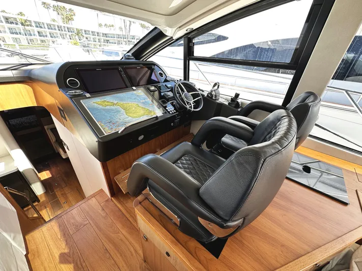 Forever Young Yacht Photos Pics Luxurious 2019 Sunseeker Predator 57 yacht cockpit with leather seats and navigation screens.