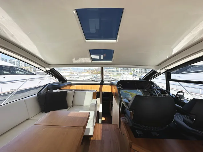 Forever Young Yacht Photos Pics Interior of 2019 Sunseeker Predator 57 yacht, featuring luxurious seating and modern navigation controls.