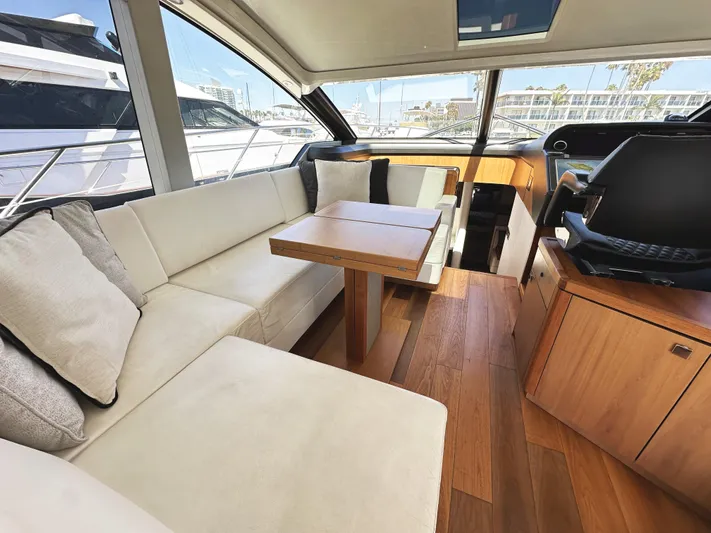 Forever Young Yacht Photos Pics Luxurious interior of 2019 Sunseeker Predator 57 yacht with elegant seating and wooden flooring.