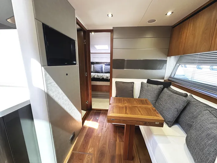 Forever Young Yacht Photos Pics Luxurious interior of 2019 Sunseeker Predator 57 yacht with modern seating and wooden accents.