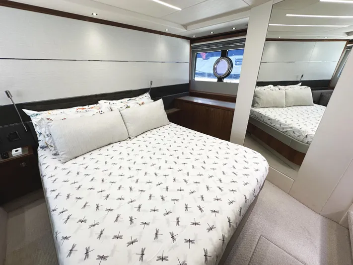 Forever Young Yacht Photos Pics Luxurious bedroom interior of 2019 Sunseeker Predator 57 yacht with elegant bedding and mirror.