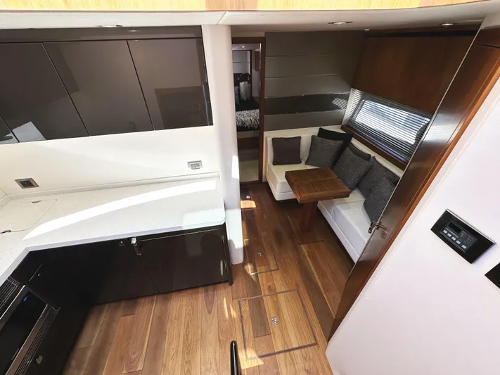 Forever Young Yacht Photos Pics Luxurious interior of 2019 Sunseeker Predator 57 yacht with modern kitchen and cozy seating area.