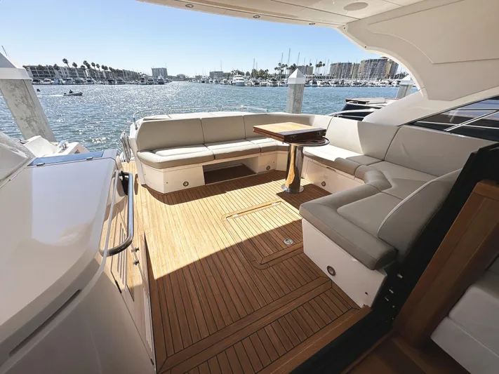 Forever Young Yacht Photos Pics Luxurious 2019 Sunseeker Predator 57 yacht deck with elegant seating and scenic marina view.