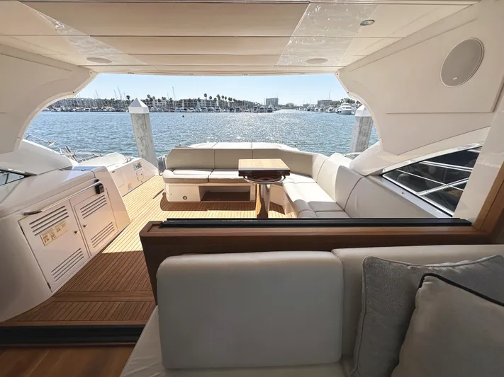 Forever Young Yacht Photos Pics Luxurious 2019 Sunseeker Predator 57 yacht interior with elegant seating and scenic ocean view.