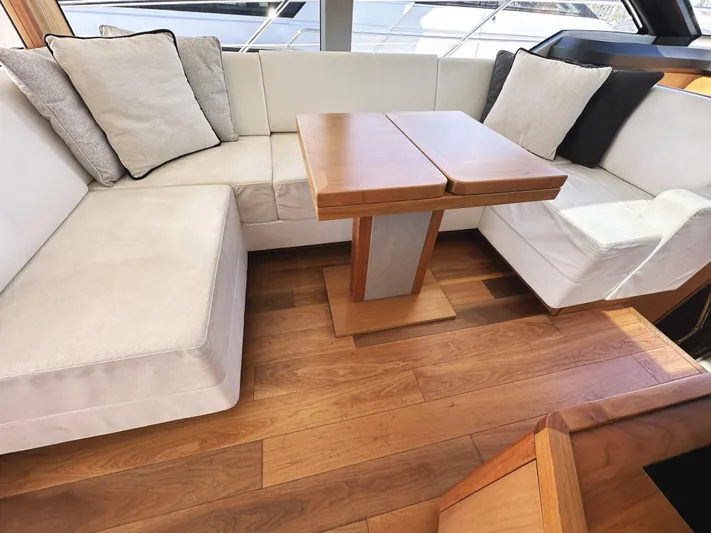 Forever Young Yacht Photos Pics Luxurious interior of 2019 Sunseeker Predator 57 yacht with elegant seating and wooden flooring.