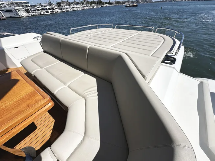 Forever Young Yacht Photos Pics Luxurious seating area on 2019 Sunseeker Predator 57 yacht, overlooking marina.