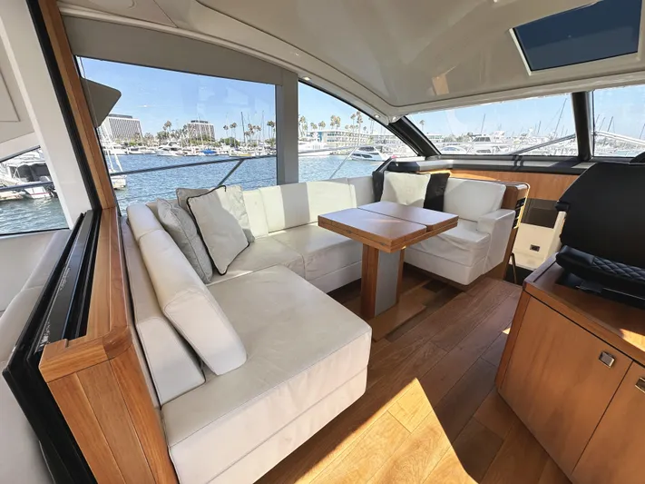 Forever Young Yacht Photos Pics Luxurious interior of 2019 Sunseeker Predator 57 yacht with elegant seating and wooden accents.