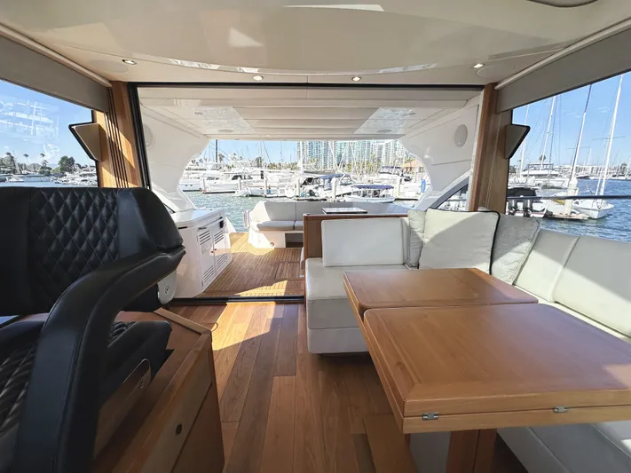 Forever Young Yacht Photos Pics Luxurious interior of 2019 Sunseeker Predator 57 yacht with elegant seating and wooden accents.