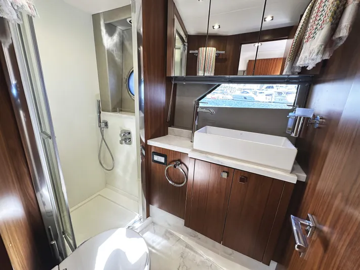 Forever Young Yacht Photos Pics Luxurious bathroom in 2019 Sunseeker Predator 57 yacht with modern fixtures and wood accents.
