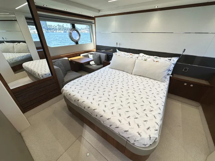 Forever Young Yacht Photos Pics Luxurious bedroom interior of 2019 Sunseeker Predator 57 yacht with scenic window view.
