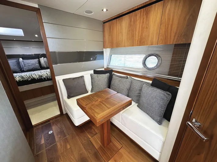 Forever Young Yacht Photos Pics Luxurious interior of 2019 Sunseeker Predator 57 yacht with elegant seating and wooden finishes.