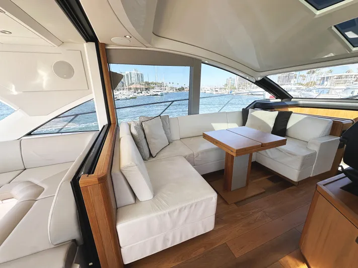 Forever Young Yacht Photos Pics Luxurious interior of 2019 Sunseeker Predator 57 yacht with elegant seating and wooden accents.