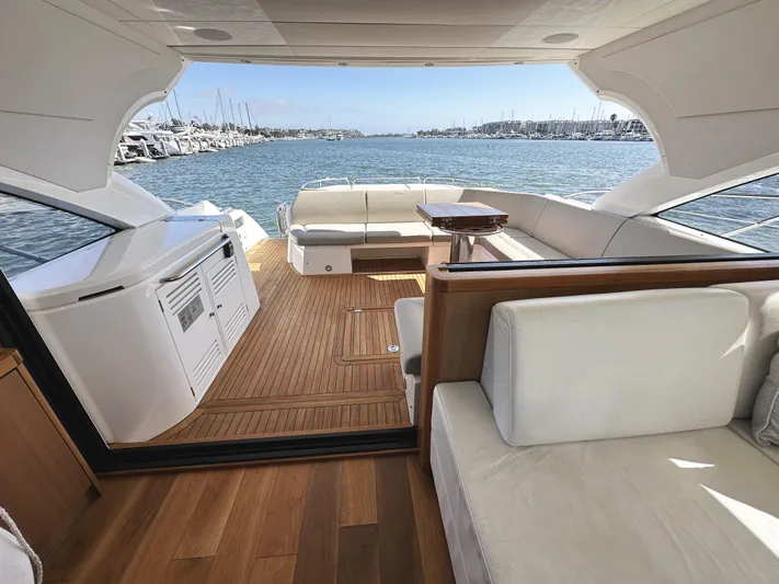 Forever Young Yacht Photos Pics Luxurious 2019 Sunseeker Predator 57 yacht interior with elegant seating and scenic marina view.