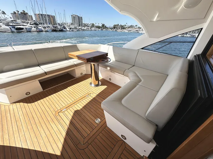 Forever Young Yacht Photos Pics Luxurious 2019 Sunseeker Predator 57 yacht interior with elegant seating and wooden deck.