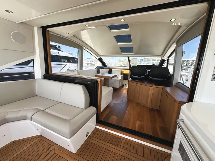 Forever Young Yacht Photos Pics Luxurious interior of 2019 Sunseeker Predator 57 yacht with elegant seating and wood flooring.
