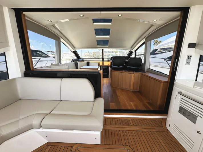 Forever Young Yacht Photos Pics Luxurious interior of 2019 Sunseeker Predator 57 yacht with modern seating and wood accents.
