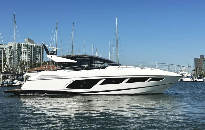 Forever Young Yacht Photos Pics 2019 Sunseeker Predator 57 yacht docked in marina, clear blue sky background.