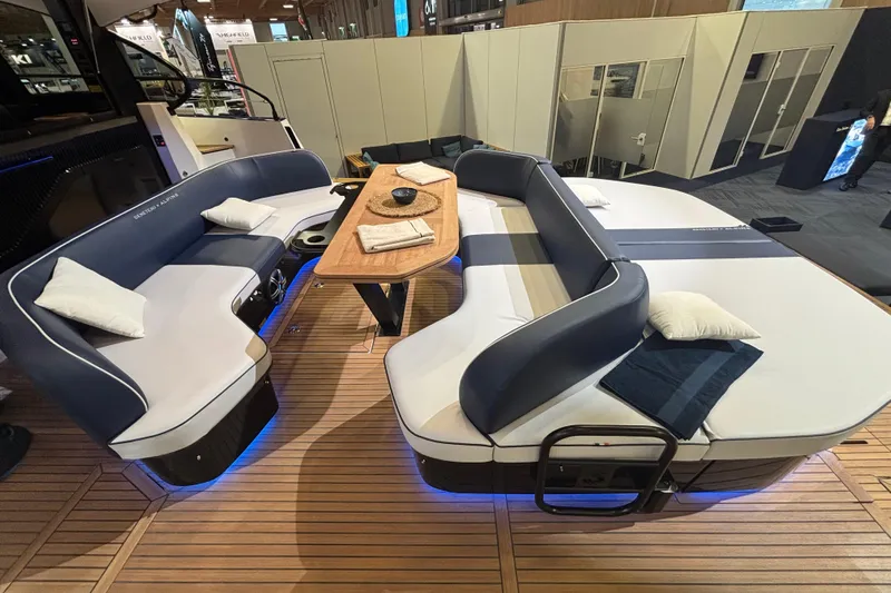  Yacht Photos Pics Luxurious seating area on 2025 Beneteau Gran Turismo 50 yacht with elegant cushions and table.