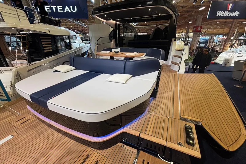  Yacht Photos Pics 2025 Beneteau Gran Turismo 50 yacht with luxurious deck and seating area at a boat show.