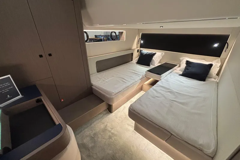  Yacht Photos Pics Luxurious cabin interior of 2025 Beneteau Gran Turismo 50 yacht with twin beds.