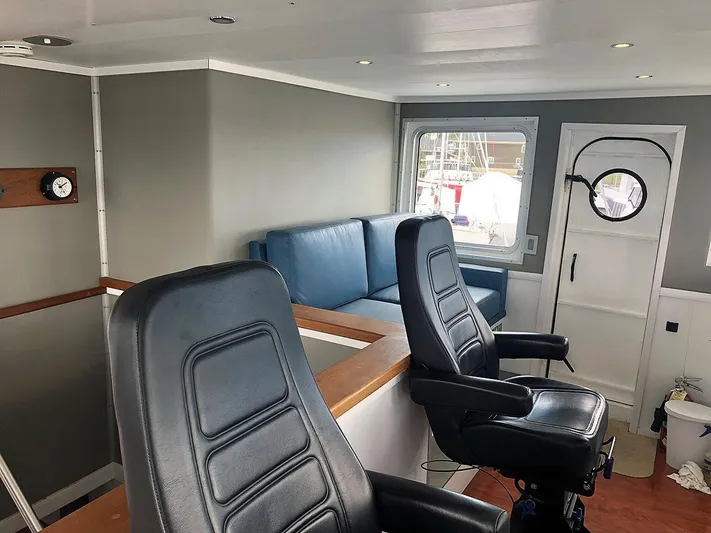 Care Bear Yacht Photos Pics Interior of 2013 Ocean Voyager 95 EXPEDITION yacht with seating and navigation area.