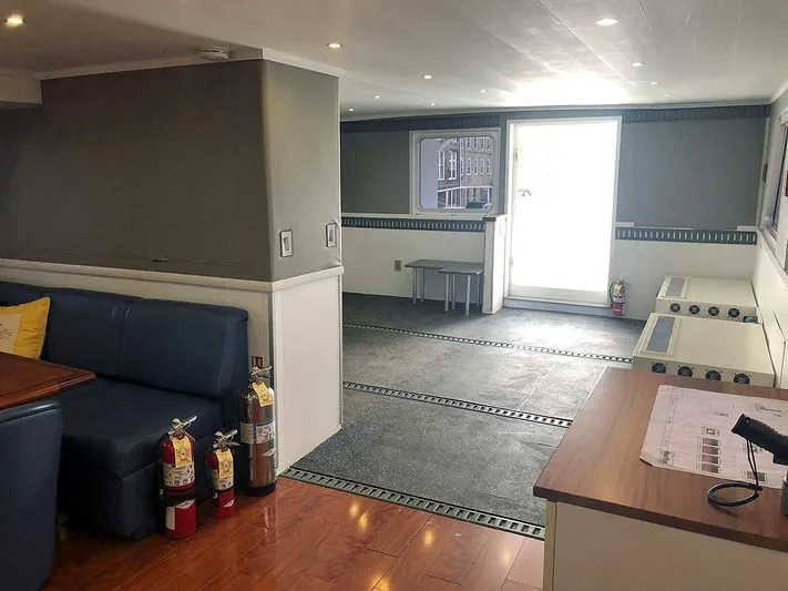 Care Bear Yacht Photos Pics Interior of 2013 Ocean Voyager 95 EXPEDITION yacht with seating area and safety equipment.