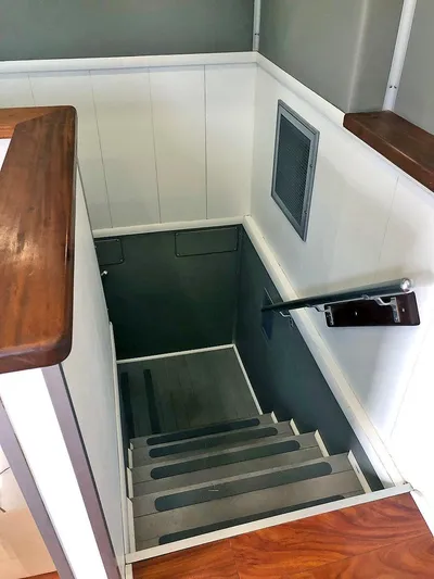 Care Bear Yacht Photos Pics Staircase inside 2013 Ocean Voyager 95 EXPEDITION yacht with wooden handrails.