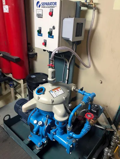 Care Bear Yacht Photos Pics Ocean Voyager 95 EXPEDITION 2013 engine room with separator system and control panel.