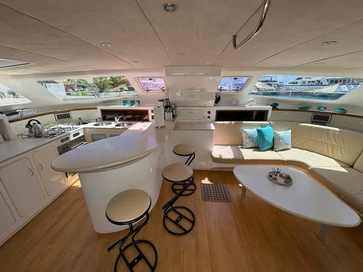 Windborne Yacht Photos Pics Luxurious interior of 2015 Voyage Yachts VOYAGE 520 with modern kitchen and seating area.