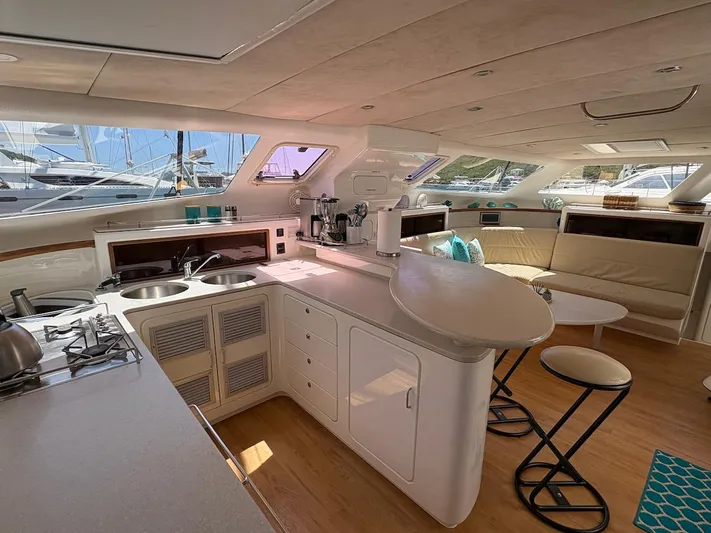 Windborne Yacht Photos Pics Luxurious interior of 2015 Voyage Yachts VOYAGE 520 with modern kitchen and seating area.