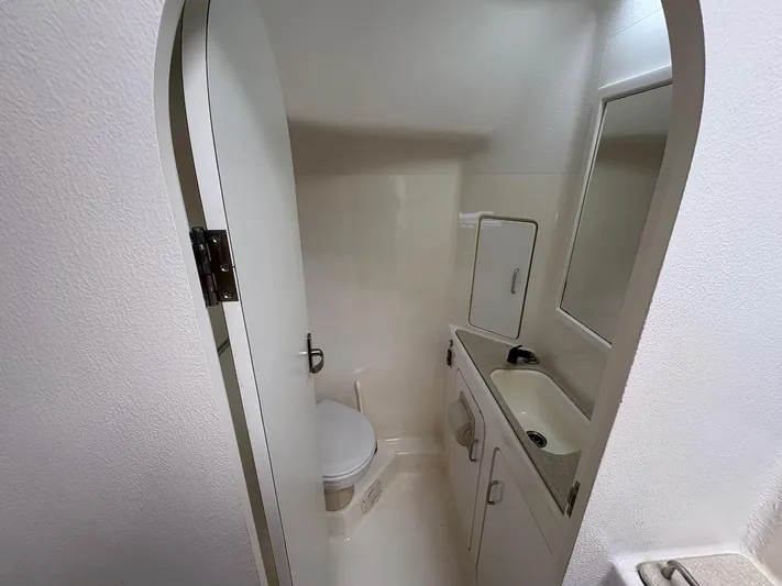 Windborne Yacht Photos Pics Compact bathroom in 2015 Voyage Yachts VOYAGE 520, featuring toilet, sink, and mirror.