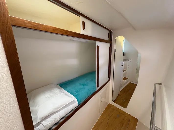 Windborne Yacht Photos Pics Cozy cabin interior of 2015 Voyage Yachts VOYAGE 520 with wooden accents and a mirror.