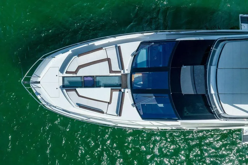  Yacht Photos Pics Aerial view of 2019 Galeon 640 Fly yacht on vibrant green water.