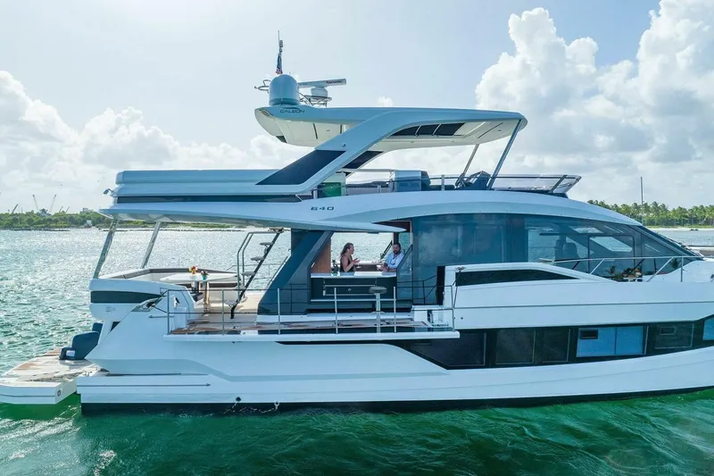  Yacht Photos Pics 2019 Galeon 640 Fly yacht cruising on a sunny day with passengers onboard.