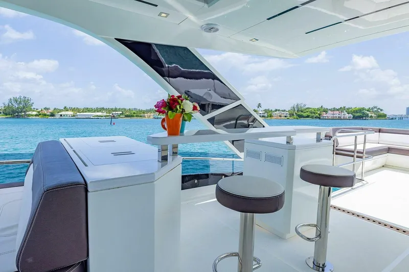  Yacht Photos Pics Luxurious 2019 Galeon 640 Fly yacht deck with bar stools and ocean view.