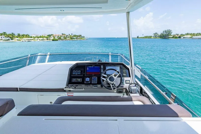  Yacht Photos Pics Cockpit view of 2019 Galeon 640 Fly yacht on serene blue waters.