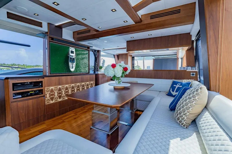  Yacht Photos Pics Luxurious interior of 2019 Galeon 640 Fly yacht with elegant wood finishes and plush seating.