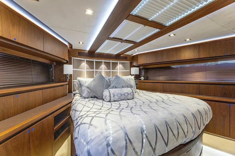 Yacht Photos Pics Luxurious bedroom interior of 2019 Galeon 640 Fly yacht with elegant wood finish.