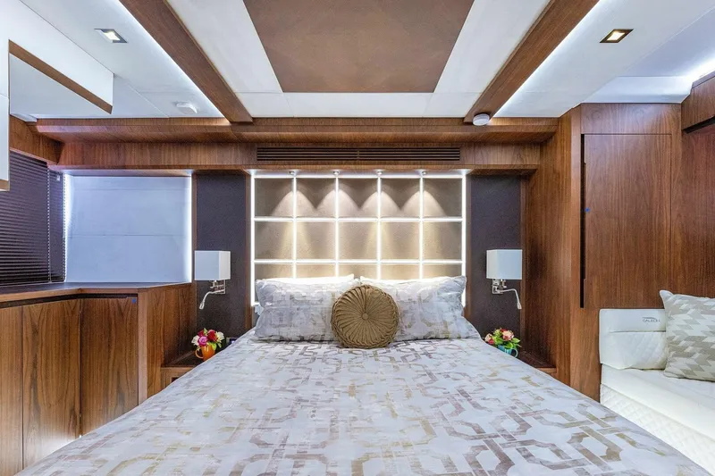 Yacht Photos Pics Luxurious bedroom interior of 2019 Galeon 640 Fly yacht with elegant wood finishes.