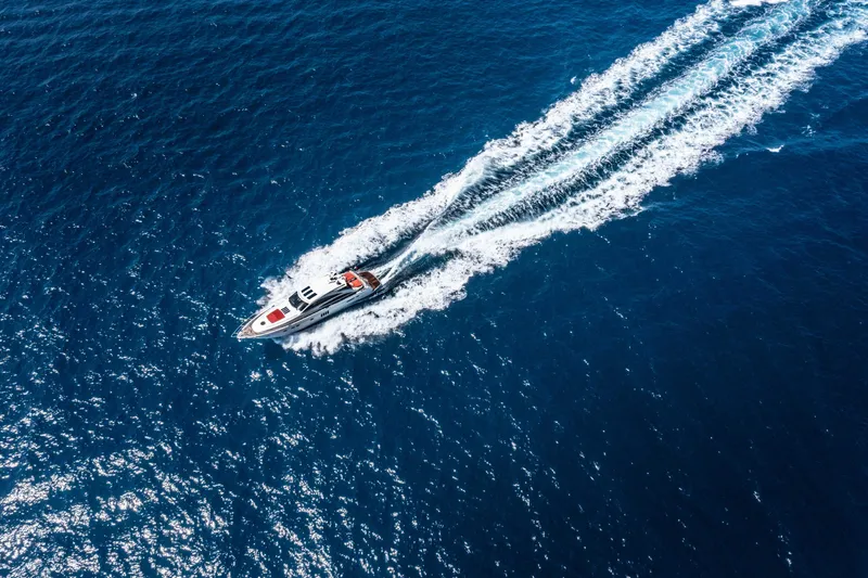  Yacht Photos Pics Aerial view of 2008 Princess V70 yacht cruising on open blue sea.