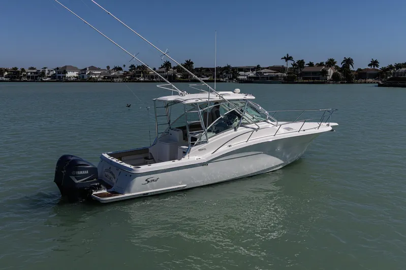 5 O' Clock Somewhere Yacht Photos Pics 2010 Scout 350 Abaco boat on calm water with Yamaha engine, coastal background.