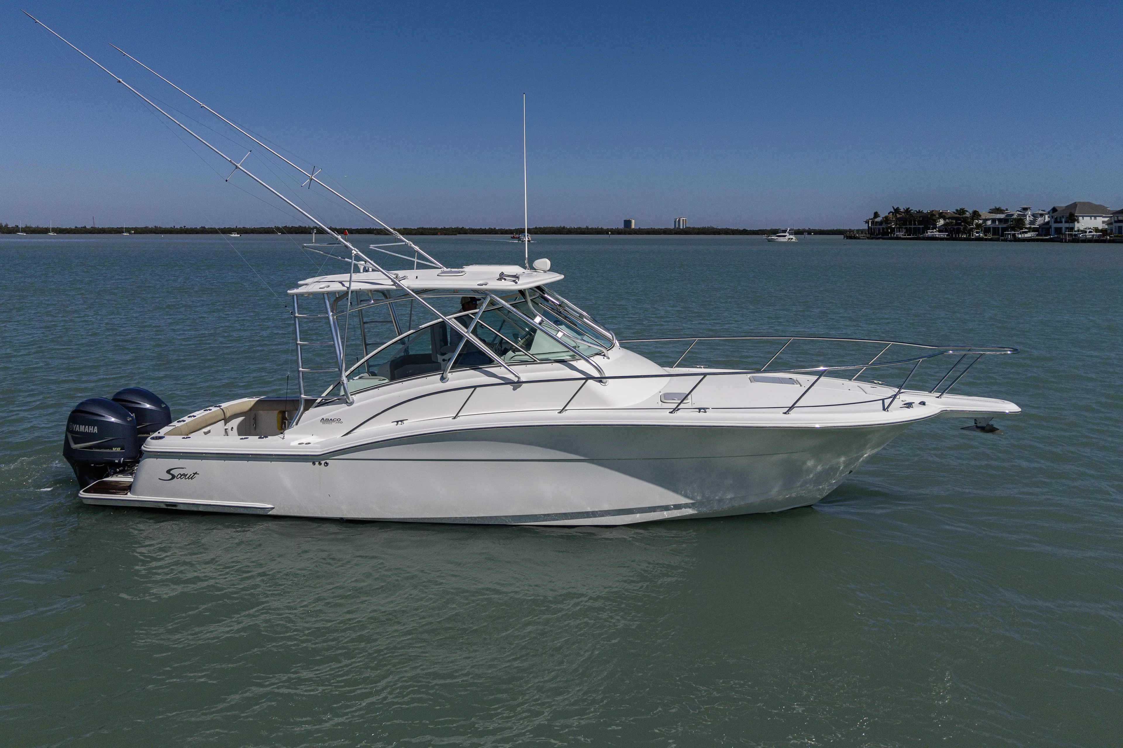 5 O' Clock Somewhere Yacht Photos Pics 2010 Scout 350 Abaco boat on calm water under clear blue sky.
