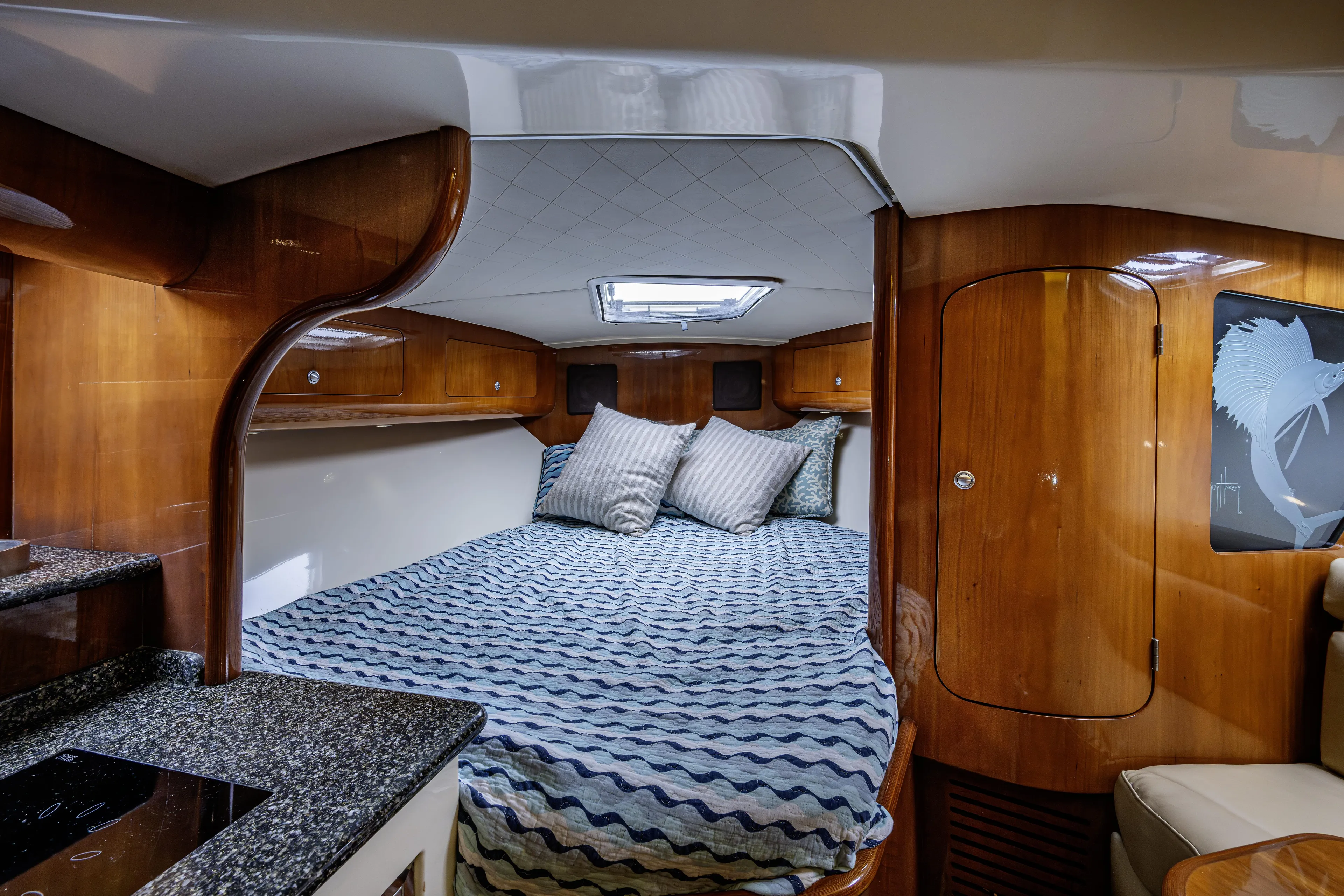 5 O' Clock Somewhere Yacht Photos Pics Luxurious cabin interior of 2010 Scout 350 Abaco boat with cozy bedding.