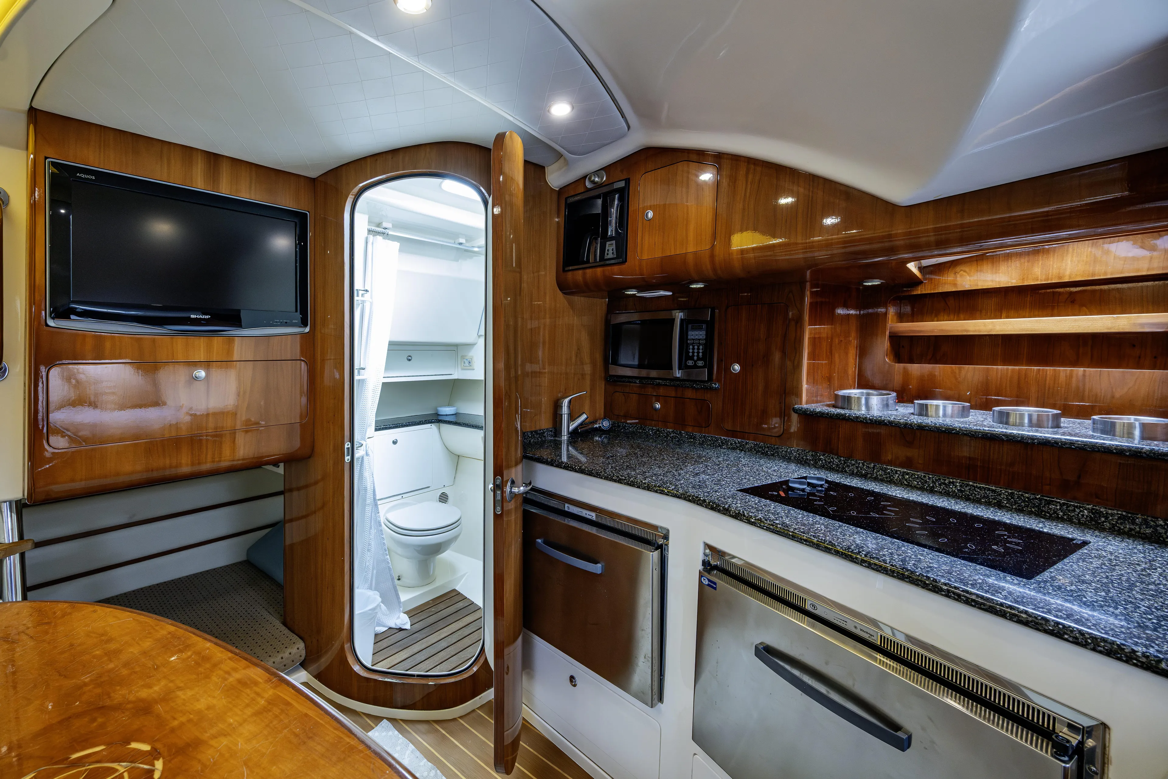 5 O' Clock Somewhere Yacht Photos Pics Luxurious 2010 Scout 350 Abaco yacht interior with modern kitchen and bathroom amenities.